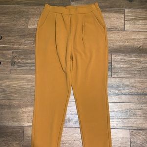 Rust/burnt orange colored dress pants with pockets